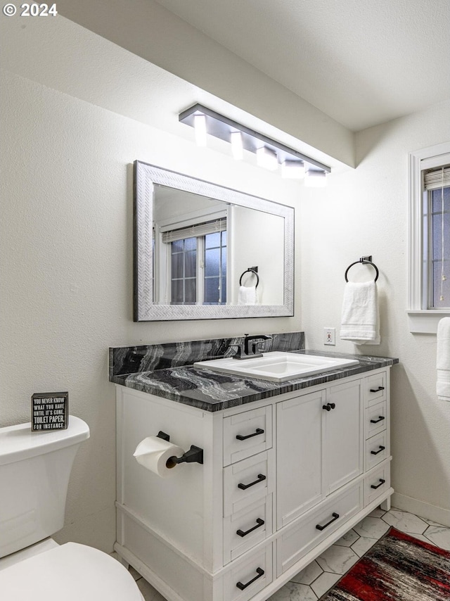 bathroom featuring vanity and toilet