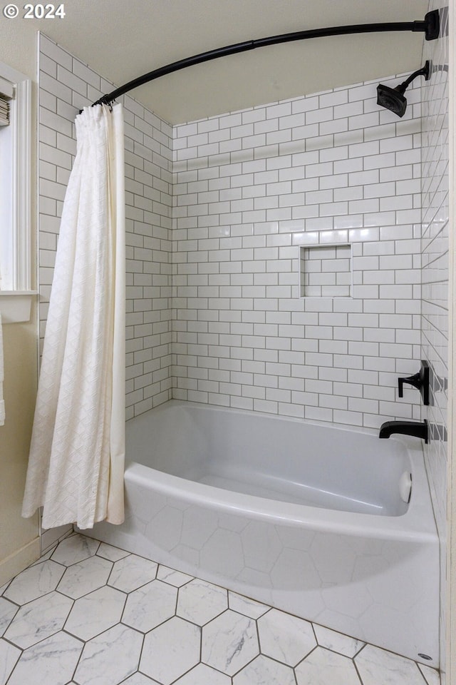 bathroom with tile patterned floors and shower / bath combo