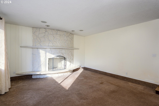 unfurnished living room with carpet and a textured ceiling