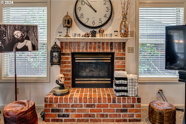 living room featuring a fireplace, carpet floors, and a healthy amount of sunlight