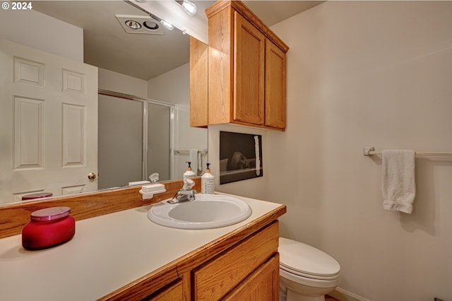 bathroom with vanity, toilet, and walk in shower