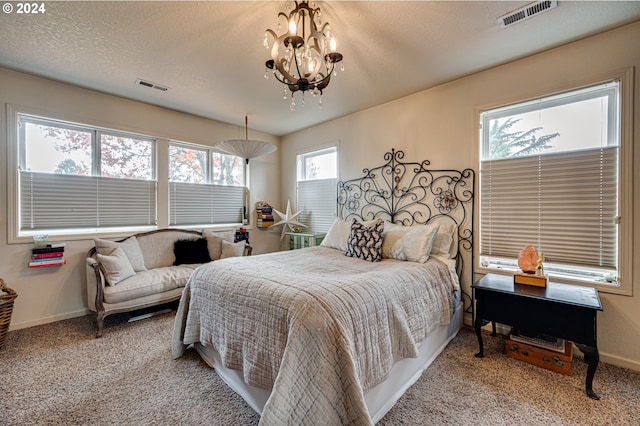 bedroom featuring carpet flooring, multiple windows, and a notable chandelier