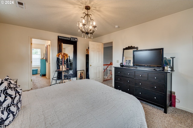 carpeted bedroom featuring a chandelier and a textured ceiling