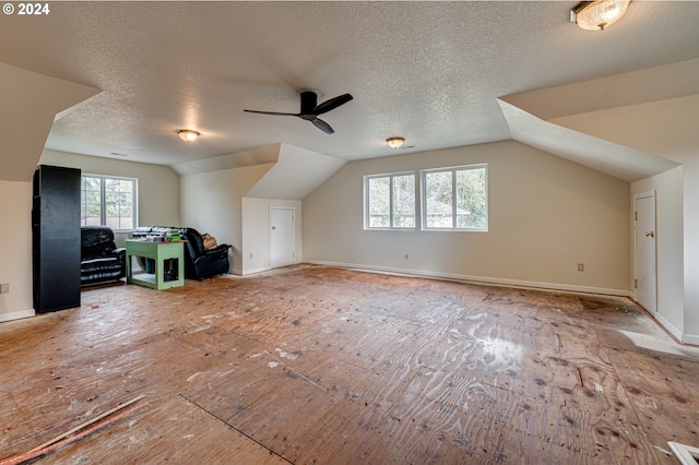 bonus room featuring vaulted ceiling, ceiling fan, and a textured ceiling