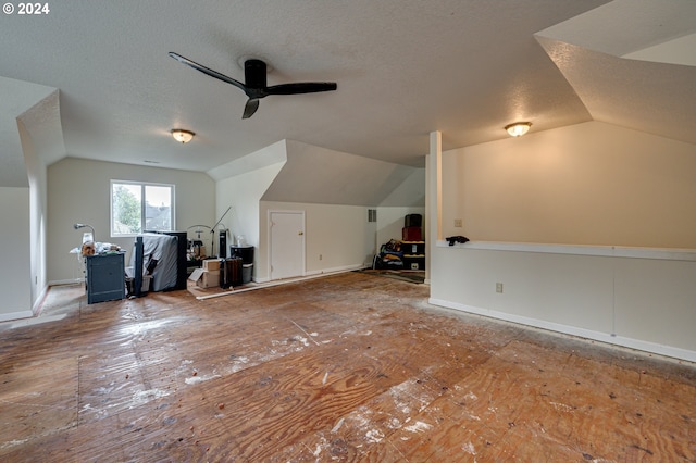 bonus room with a textured ceiling, ceiling fan, and lofted ceiling