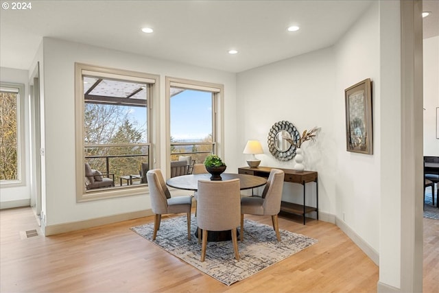 dining space with light hardwood / wood-style floors