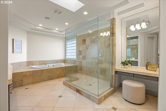 bathroom with tile patterned flooring, shower with separate bathtub, and vanity