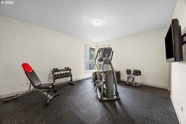 workout room with a textured ceiling