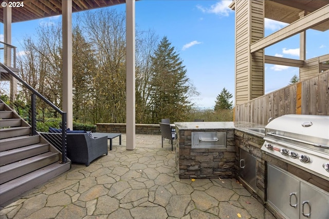 view of patio / terrace with area for grilling, exterior kitchen, and an outdoor bar