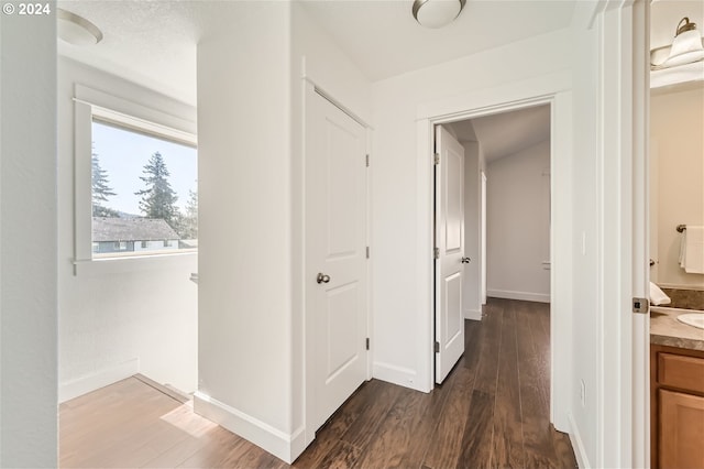 corridor with dark hardwood / wood-style floors