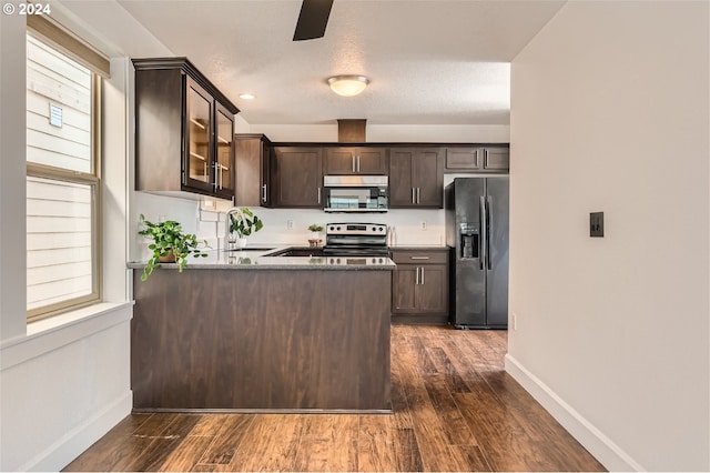 kitchen featuring dark brown cabinets, plenty of natural light, sink, and appliances with stainless steel finishes