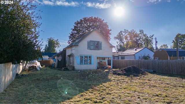 rear view of property featuring a yard