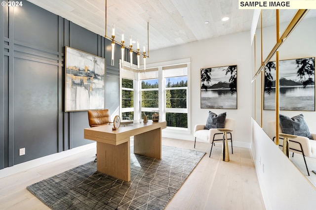 home office featuring wood-type flooring and a notable chandelier