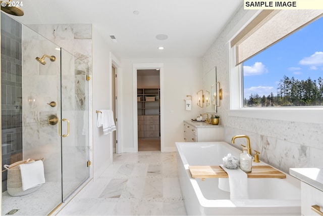 bathroom with vanity and separate shower and tub