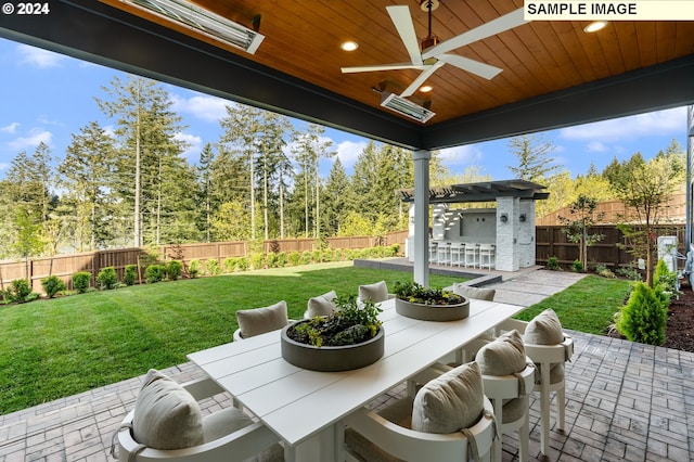 view of patio with ceiling fan and a bar