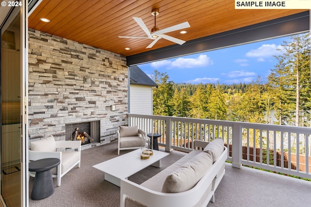 view of patio / terrace with an outdoor living space with a fireplace and ceiling fan