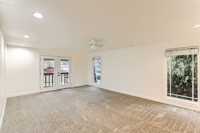 carpeted empty room featuring french doors and ceiling fan