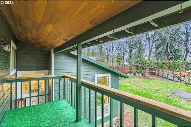 wooden deck with a lawn