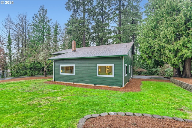 view of side of property with a yard