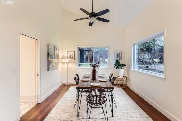 dining space featuring dark hardwood / wood-style flooring, high vaulted ceiling, and ceiling fan