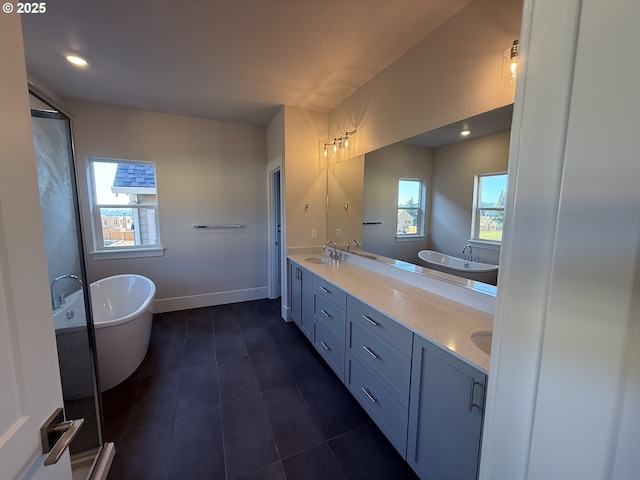 bathroom featuring vanity, tile patterned floors, a healthy amount of sunlight, and plus walk in shower