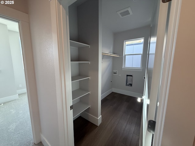 clothes washing area featuring dark carpet and washer hookup