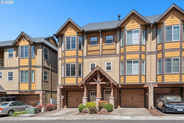 19639 SW Blackbear Ct, Beaverton, OR 97006 - view of property featuring an attached garage, stone siding, and driveway