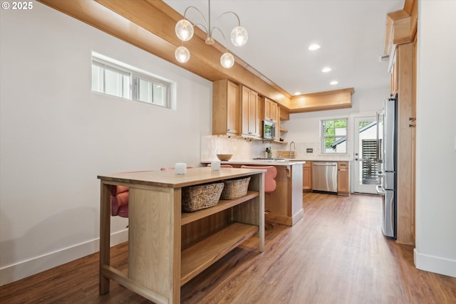 19639 SW Blackbear Ct, Beaverton, OR 97006 - kitchen with open shelves, appliances with stainless steel finishes, light countertops, a kitchen breakfast bar, and baseboards