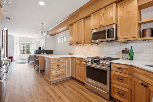 19639 SW Blackbear Ct, Beaverton, OR 97006 - kitchen featuring appliances with stainless steel finishes, open shelves, open floor plan, a peninsula, and recessed lighting