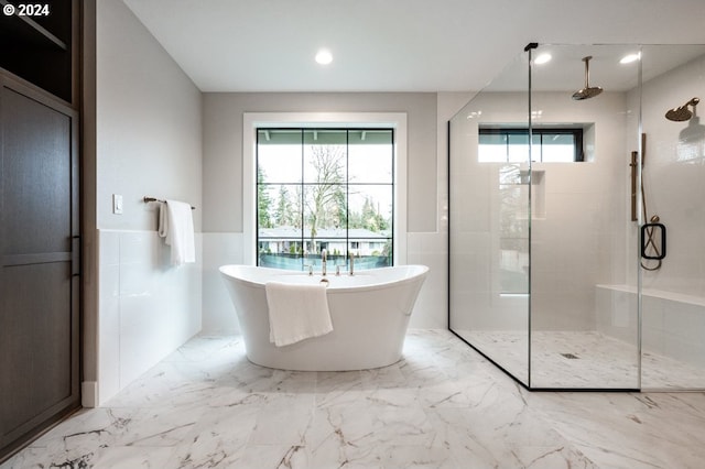 bathroom featuring separate shower and tub