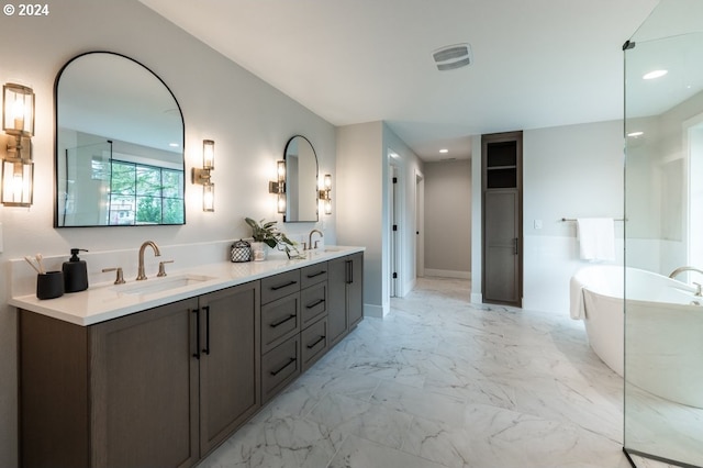 bathroom with a washtub and vanity