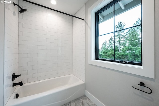 bathroom with tile patterned flooring and tiled shower / bath combo