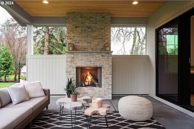 view of patio / terrace with an outdoor living space with a fireplace