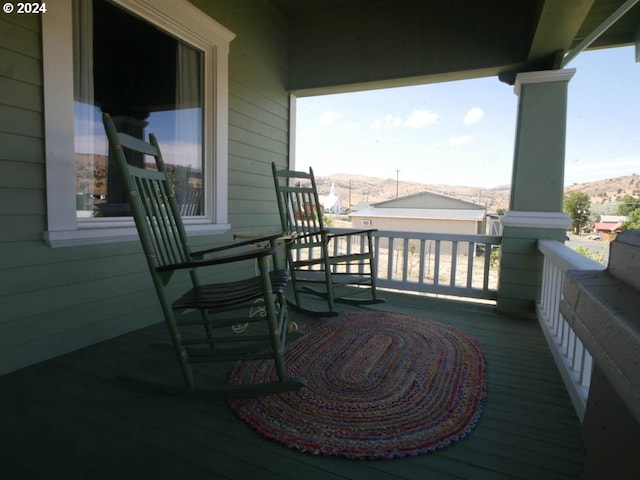 balcony with a mountain view and covered porch