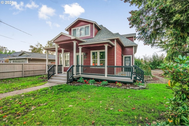 view of front of property featuring covered porch and a front yard