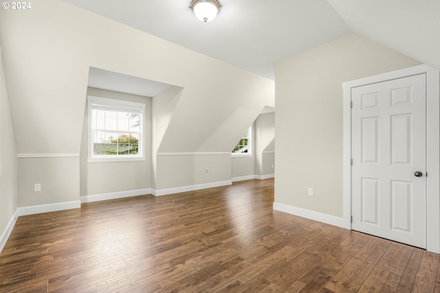 bonus room featuring vaulted ceiling and dark hardwood / wood-style flooring