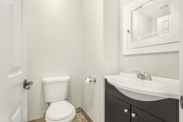 bathroom with tile patterned floors, vanity, and toilet