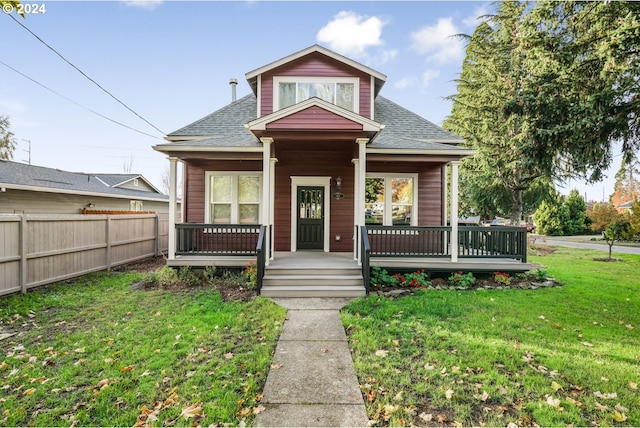 bungalow-style home with covered porch and a front yard