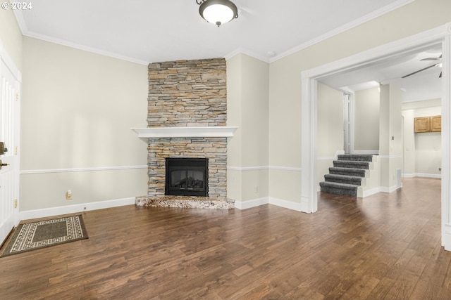 unfurnished living room featuring hardwood / wood-style flooring, a stone fireplace, and crown molding