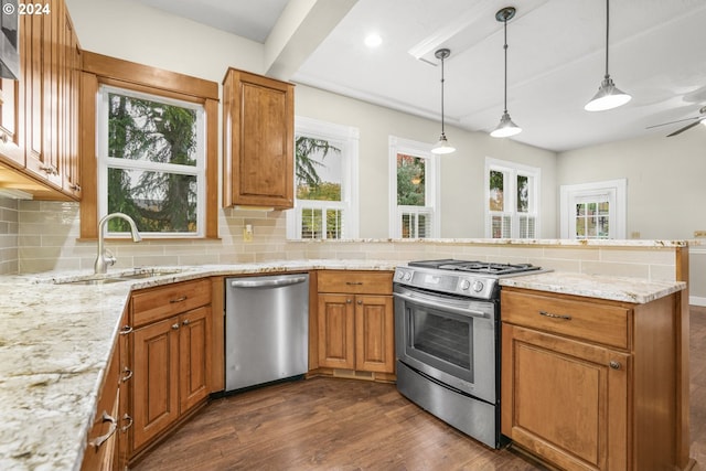 kitchen featuring decorative backsplash, stainless steel appliances, light stone countertops, and dark hardwood / wood-style flooring