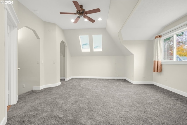 bonus room with vaulted ceiling, ceiling fan, and carpet floors