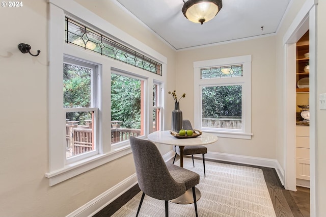 interior space featuring crown molding and dark hardwood / wood-style flooring