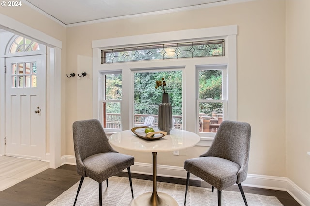 dining area featuring crown molding and dark wood-type flooring