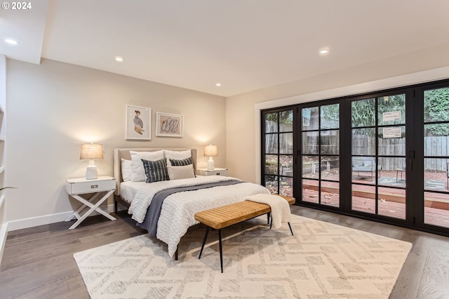 bedroom featuring access to exterior and hardwood / wood-style floors