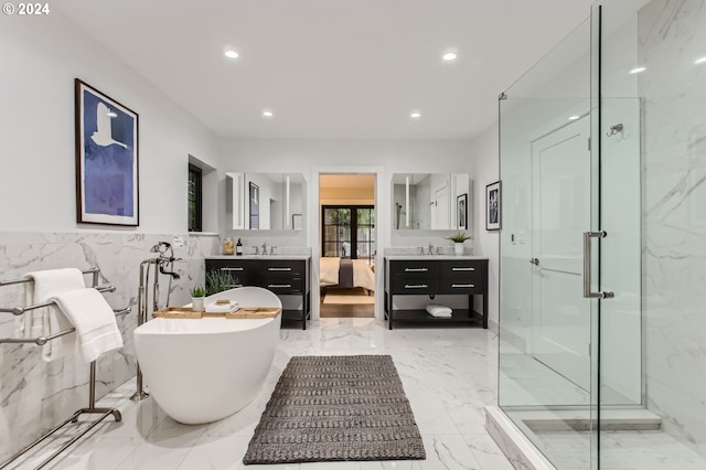 bathroom featuring vanity, plus walk in shower, and tile walls