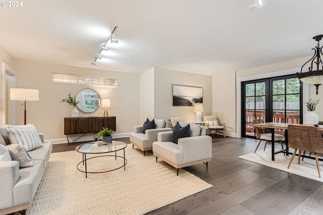 living room with track lighting and dark hardwood / wood-style flooring