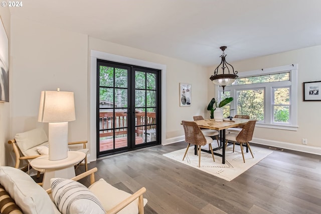 dining space with hardwood / wood-style flooring