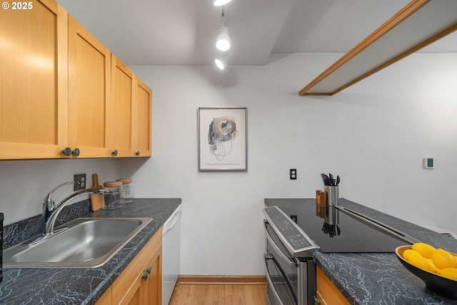 kitchen featuring light wood-type flooring, stainless steel range with electric cooktop, sink, white dishwasher, and light brown cabinetry