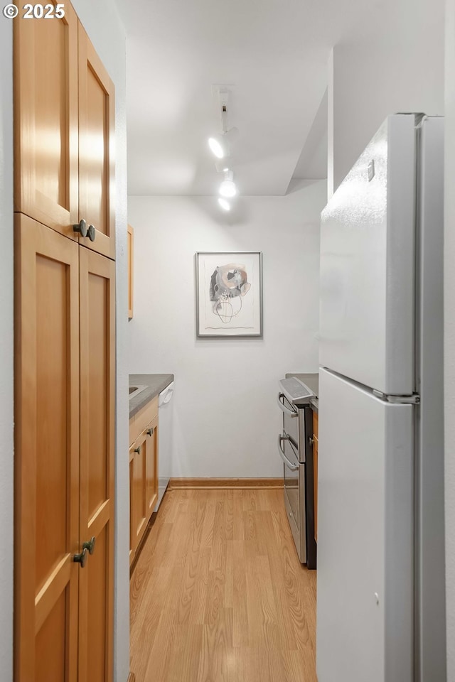 kitchen with white appliances and light wood-type flooring