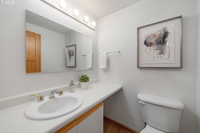 bathroom with toilet and vanity